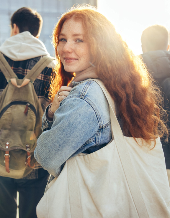 Girl with bag looking at camera